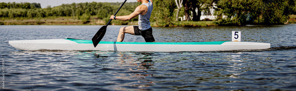 man athlete canoeist rowing in canoe competition race