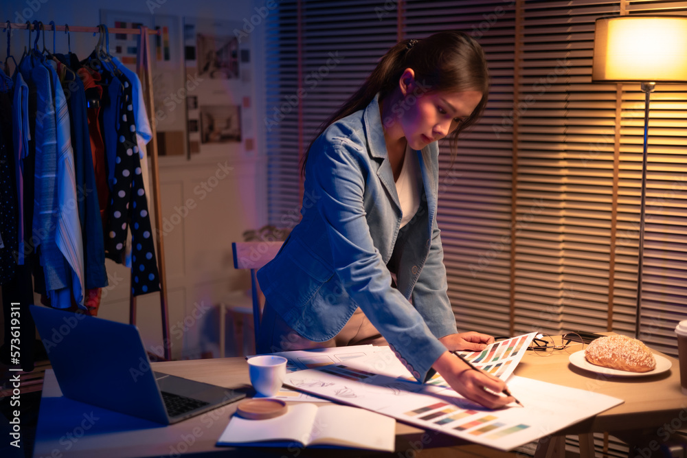 Young beautiful woman in   shirt work late from home in living room at late night overtime.Businessw