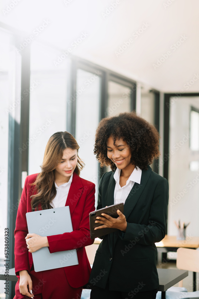 Businesswomen work and discuss their business plans. A Human employee explains and shows her colleag