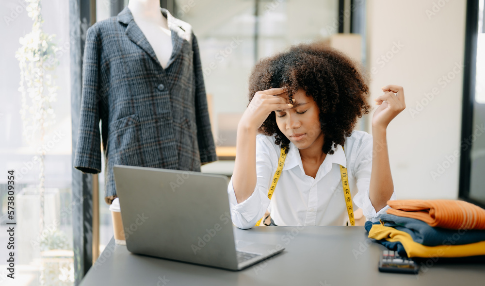 Asian business woman is stressed, bored, and overthinking from working on a tablet at the modern off