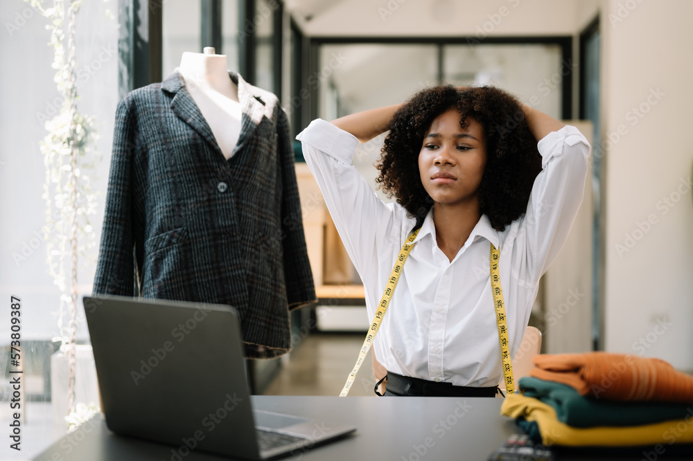 Asian business woman is stressed, bored, and overthinking from working on a tablet at the modern off