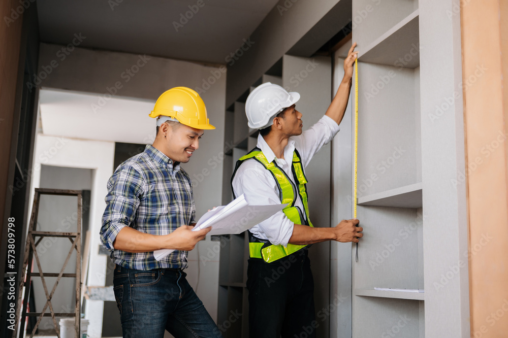 Handsome young man team architect on a building industry construction site in son light