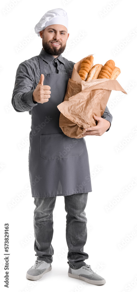 Male baker with fresh baguettes showing thumb-up on white background