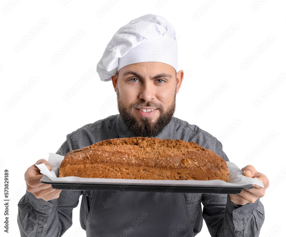 Male baker holding tray with rye bread on white background