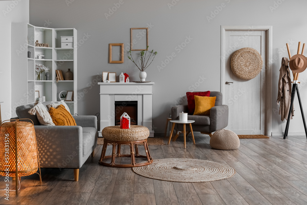 Interior of living room with fireplace, tables and house candle holders