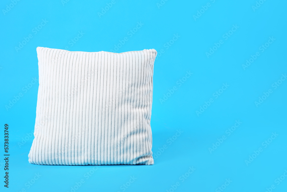 Soft pillow on blue background