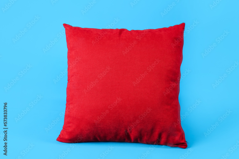 Red pillow on blue background