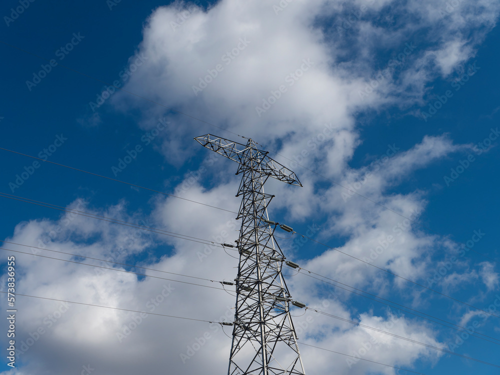 下から見上げる送電塔と青空の風景