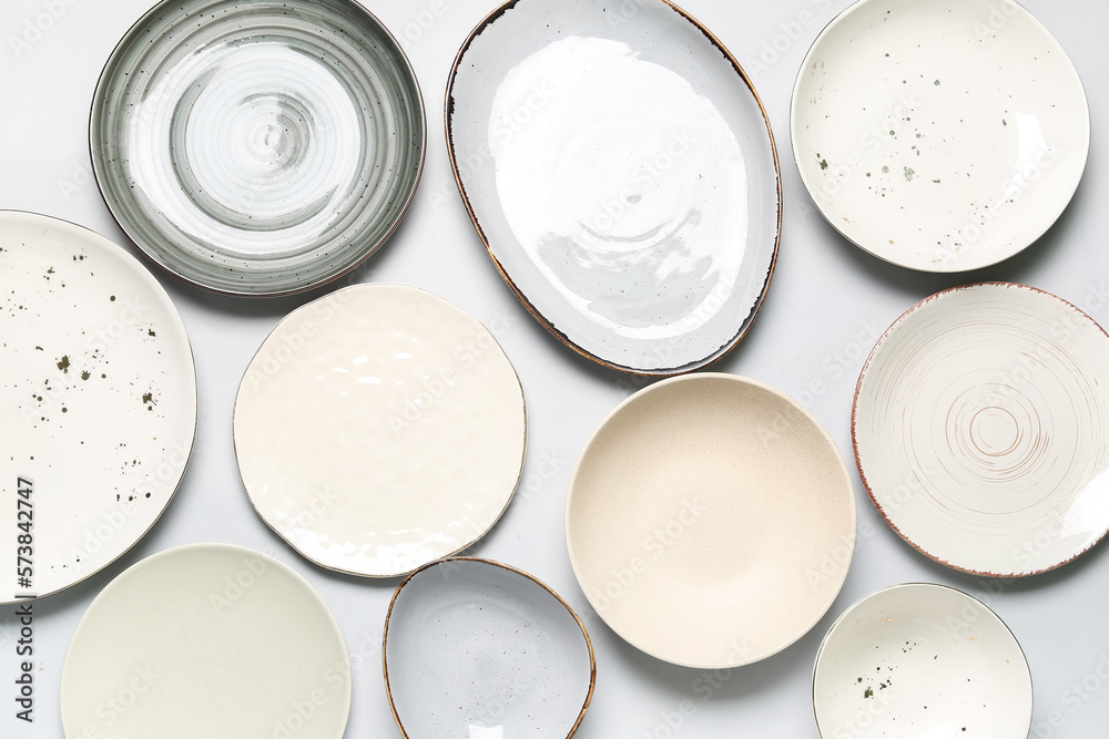 Composition with clean ceramic plates on white background