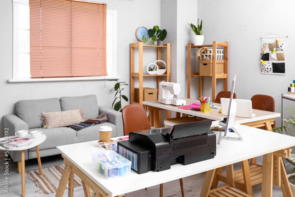 Interior of atelier with tailors workplace and sofa