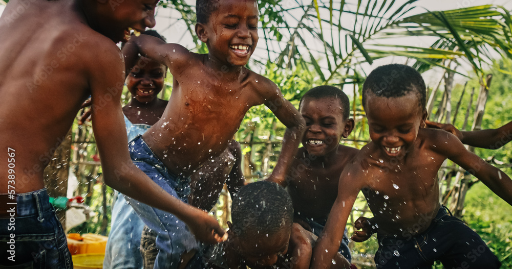 A Group Of African Children, Laughing, Jumping And Playing in Rural Area. Black Kids Celebrating Lif