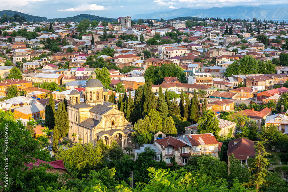 Cityscape of Kutaisi with Bagrati Cathedral and colorful residential buildings and houses during sun