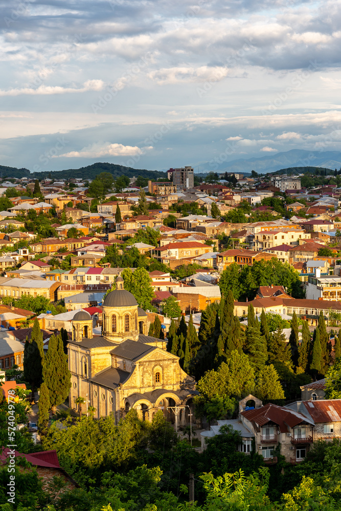 Cityscape of Kutaisi with Bagrati Cathedral and colorful residential buildings and houses during sun