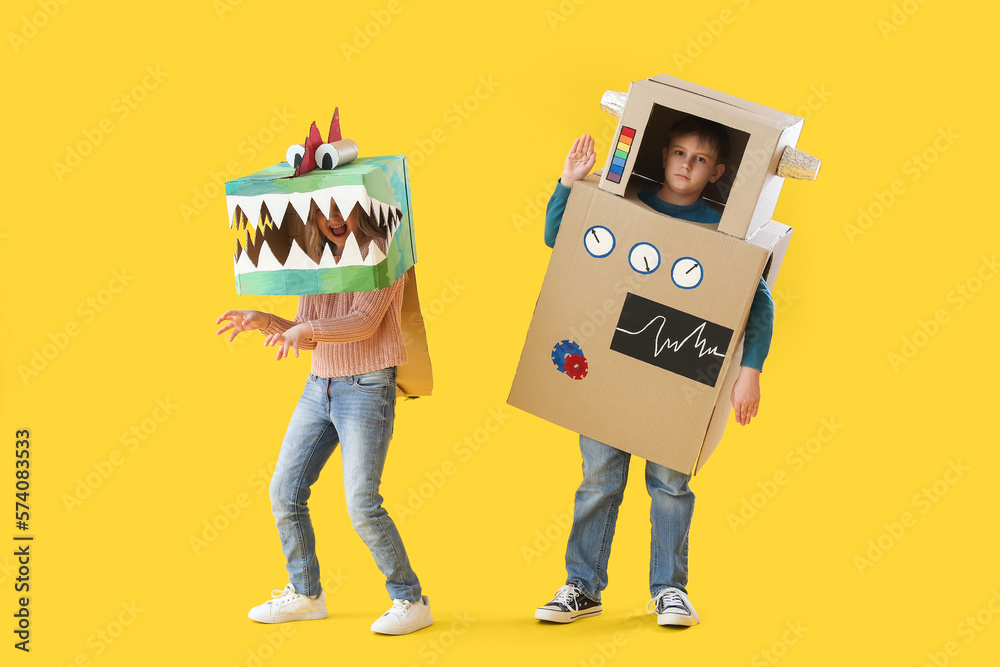 Little children in cardboard costumes on yellow background