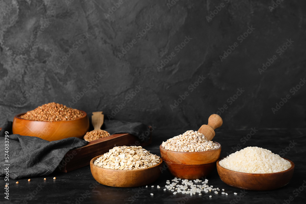 Bowls with cereals on dark background