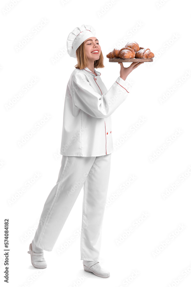 Female baker with board of tasty croissants on white background