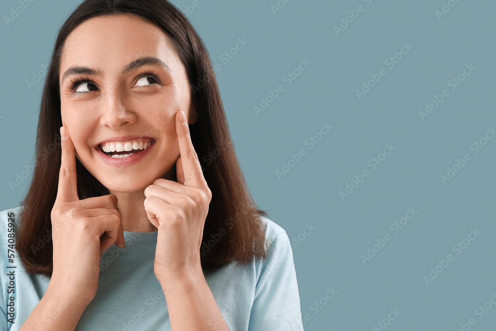 Thinking young woman on blue background, closeup