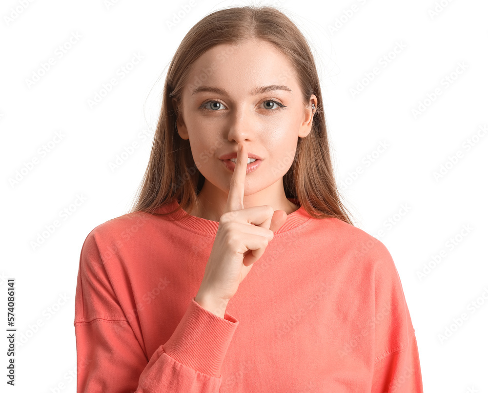 Young woman in red sweatshirt showing silence gesture on white background, closeup