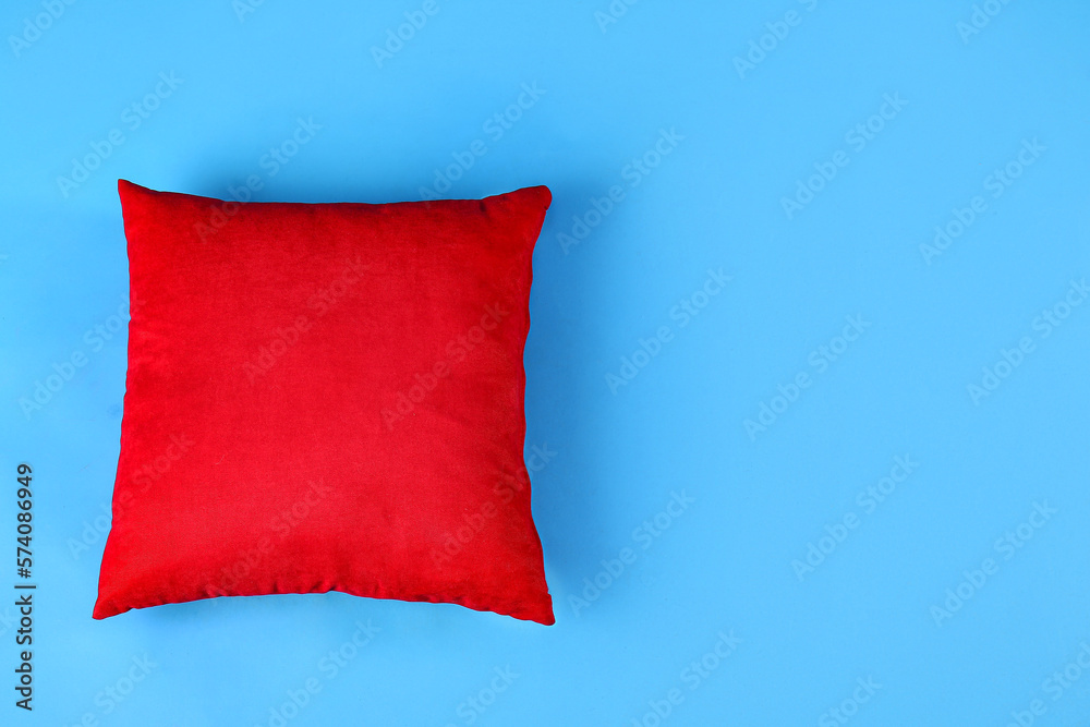 Red pillow on blue background