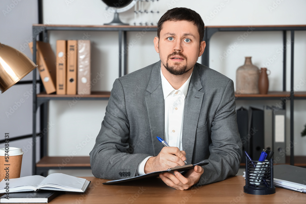 Male tutor with clipboard giving online lesson at home