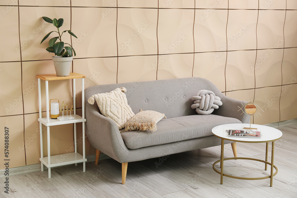 Interior of living room with grey couch and shelving unit