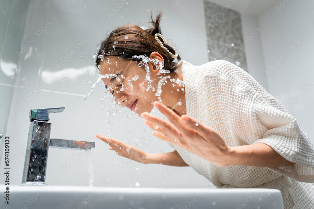 Asian beautiful woman washing her clean face with facial foam and water. 