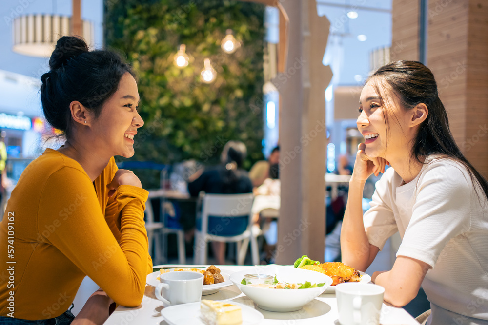 Asian beautiful women having dinner with friend in restaurant together. 