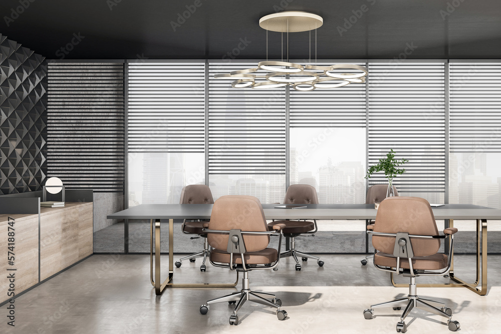 Empty grey conference table surrounded by wheel chairs on concrete floor in spacious sunlit meeting 