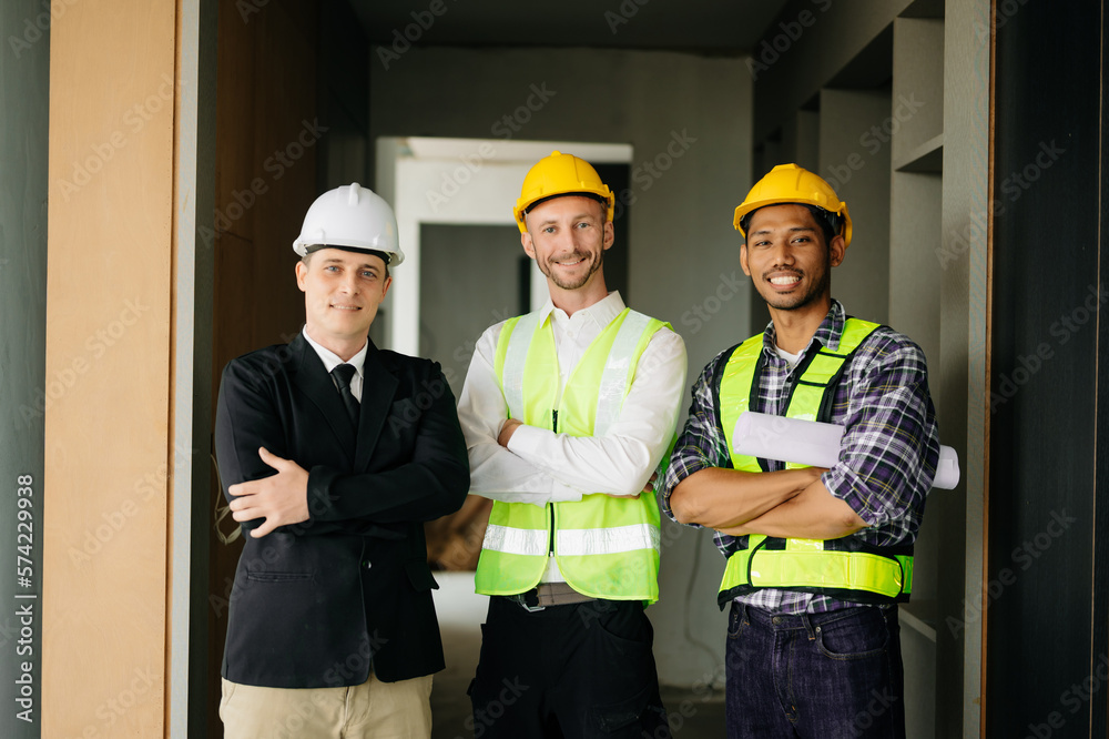 Architect caucasian man working with colleagues mixed race in the construction site. Architecture en