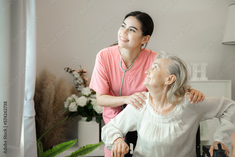 Professional helpful caregiver comforting senior woman at nursing home,Senior services and geriatric