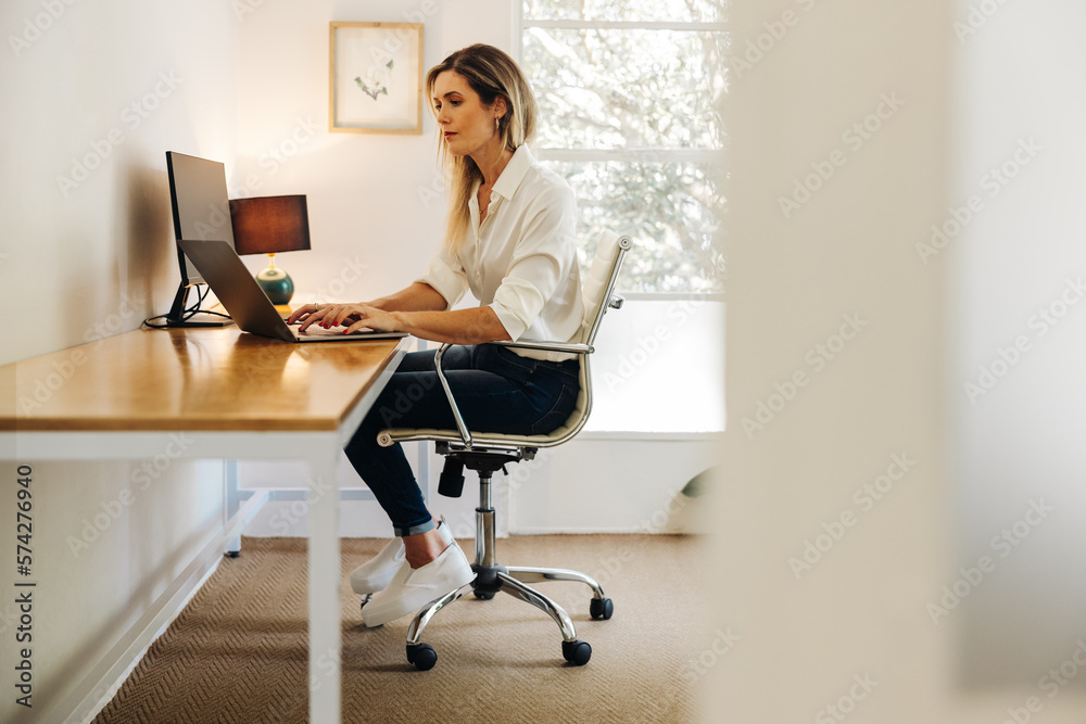 Businesswoman working on a laptop in her home office