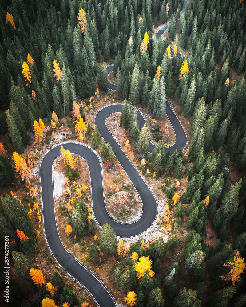 Top aerial view of famous Snake road near Passo Giau in Dolomite Alps. Winding mountains road in lus