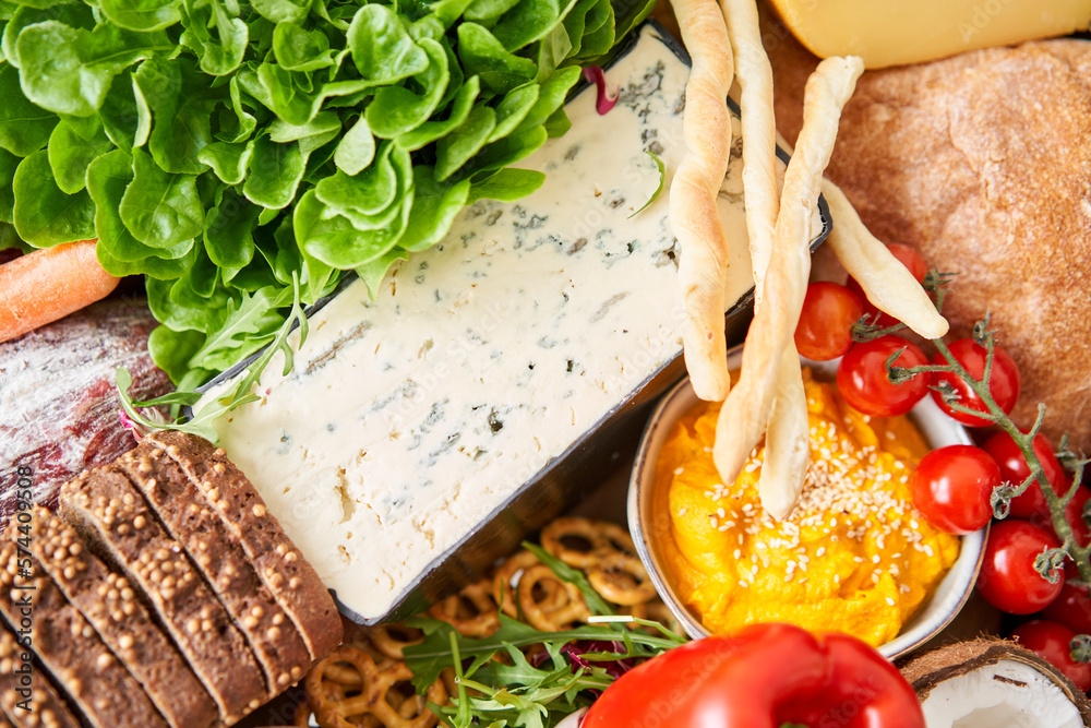 Gorgonzola cheese close-up. Table full of mediterranean appetizers, tapas or antipasto. Assorted Ita