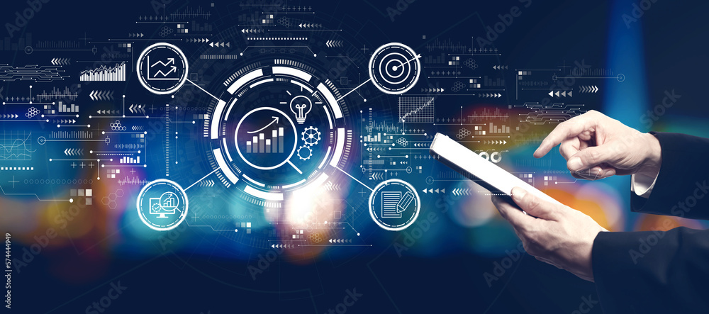 Data Analysis concept with businessman using a tablet computer at night