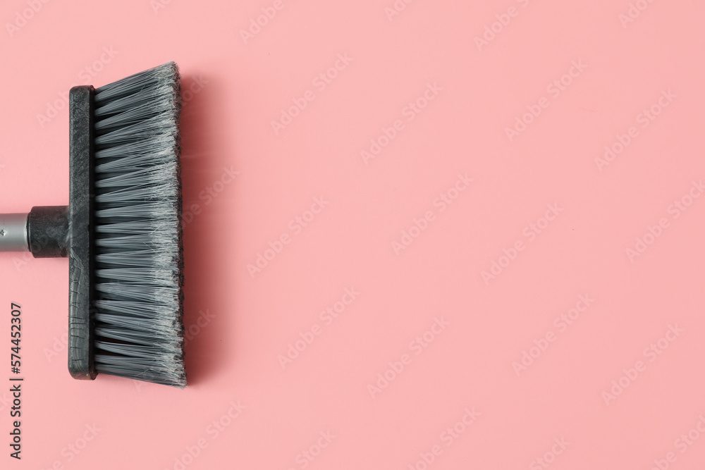 Plastic cleaning broom on pink background