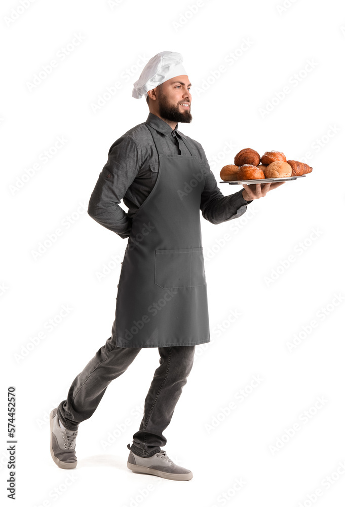 Male baker holding tray with pastries on white background