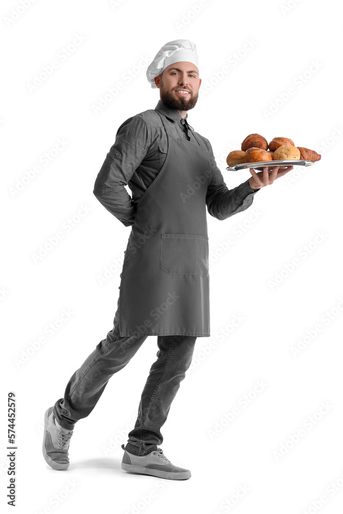 Male baker holding tray with pastries on white background