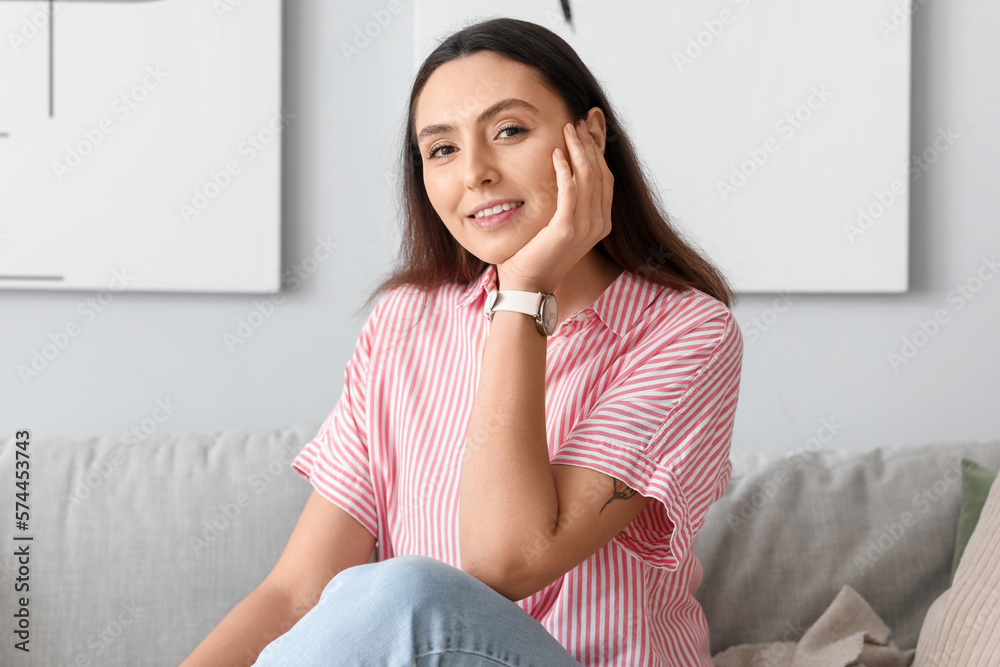 Young woman with stylish wristwatch at home