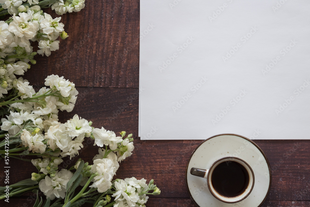 notebook, flowers  and coffee on wood texture