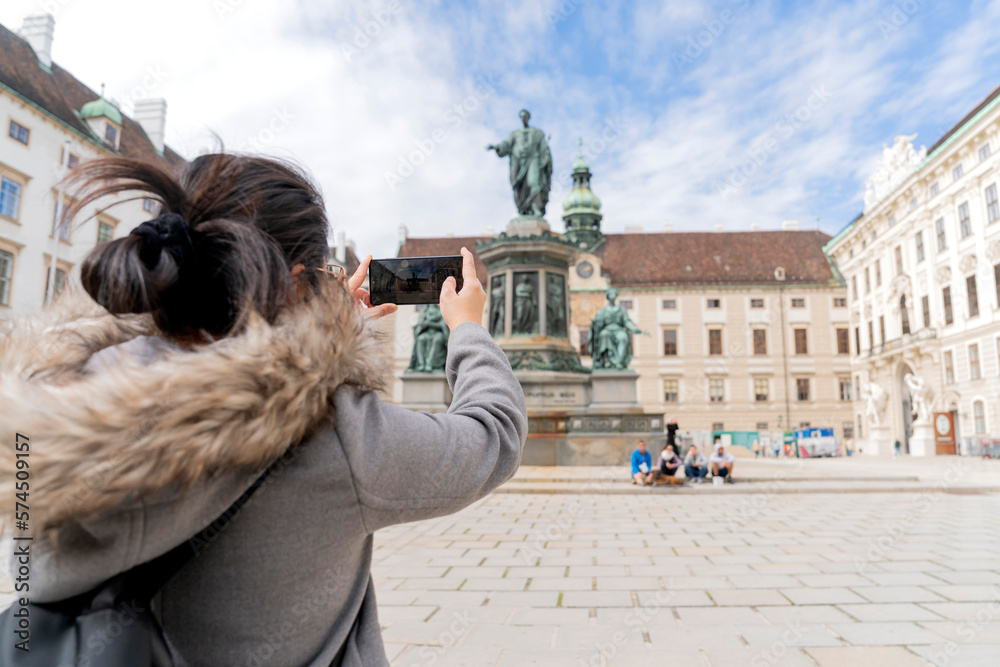 asian female woman traveller enjoy holiday vacation city walking hand using smartphone taking photo 