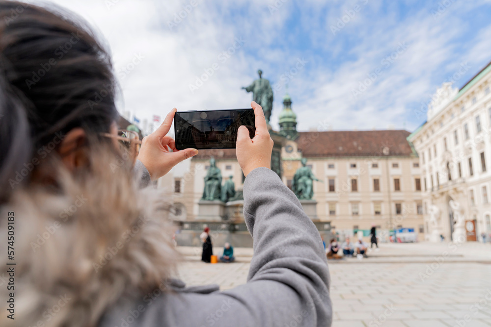 asian female woman traveller enjoy holiday vacation city walking hand using smartphone taking photo 