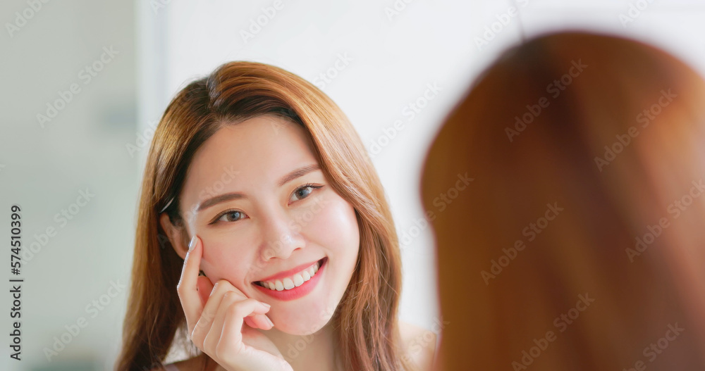 woman is looking in mirror