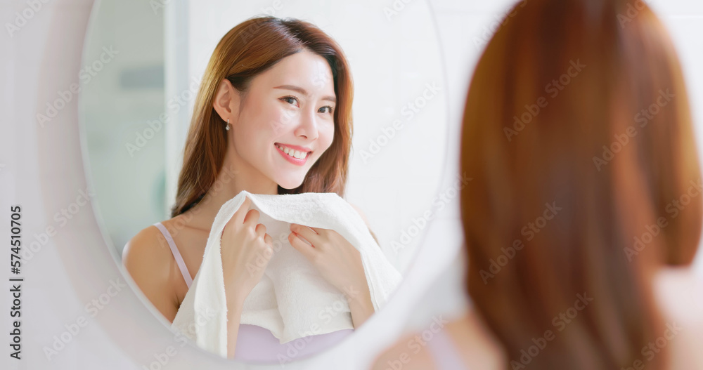 woman clean face by towel