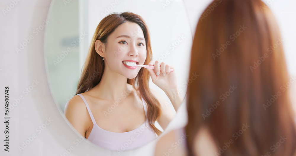 asian smiling woman brush teeth