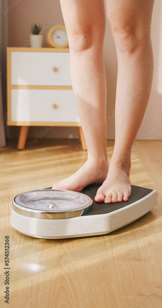 woman measure weight on scale