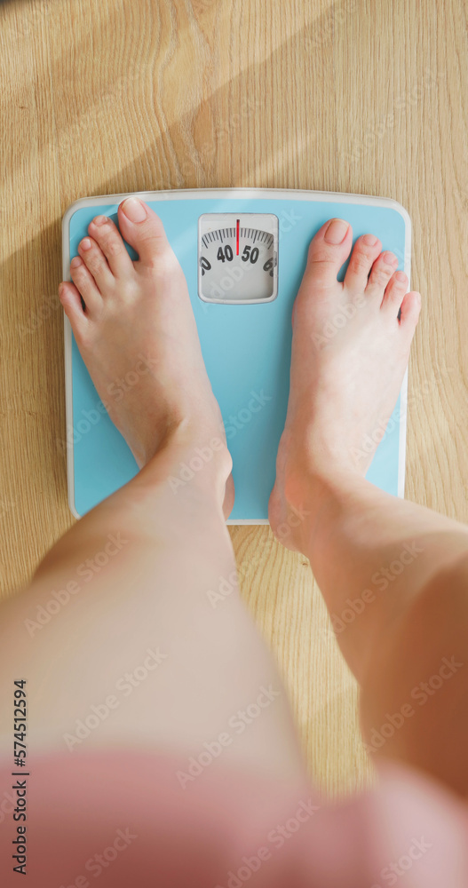 woman measure weight on scale