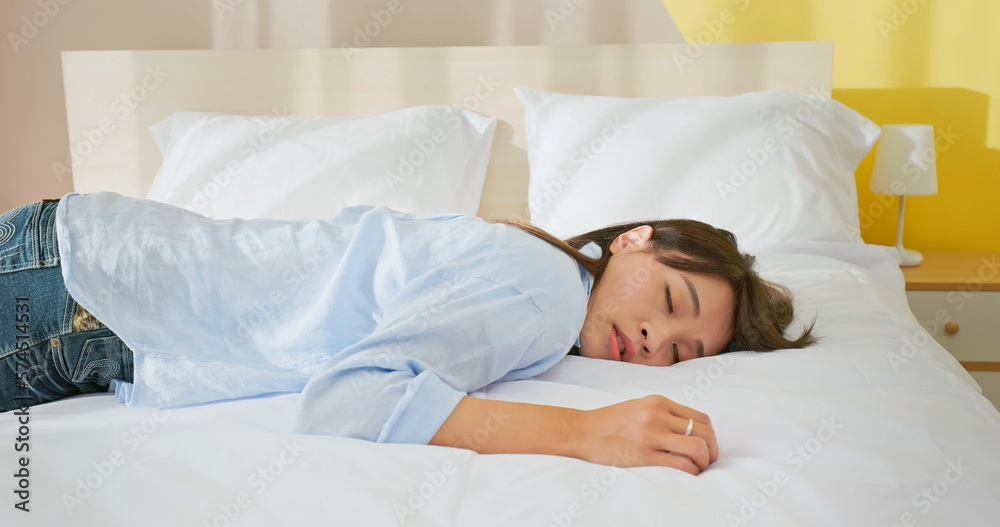 tired woman lying on bed