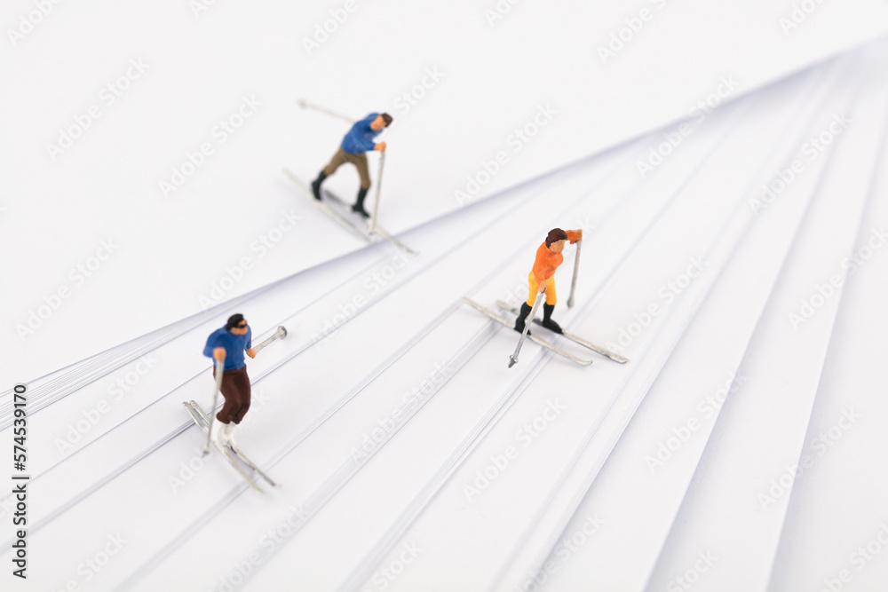 Miniature scene skiing on white paper