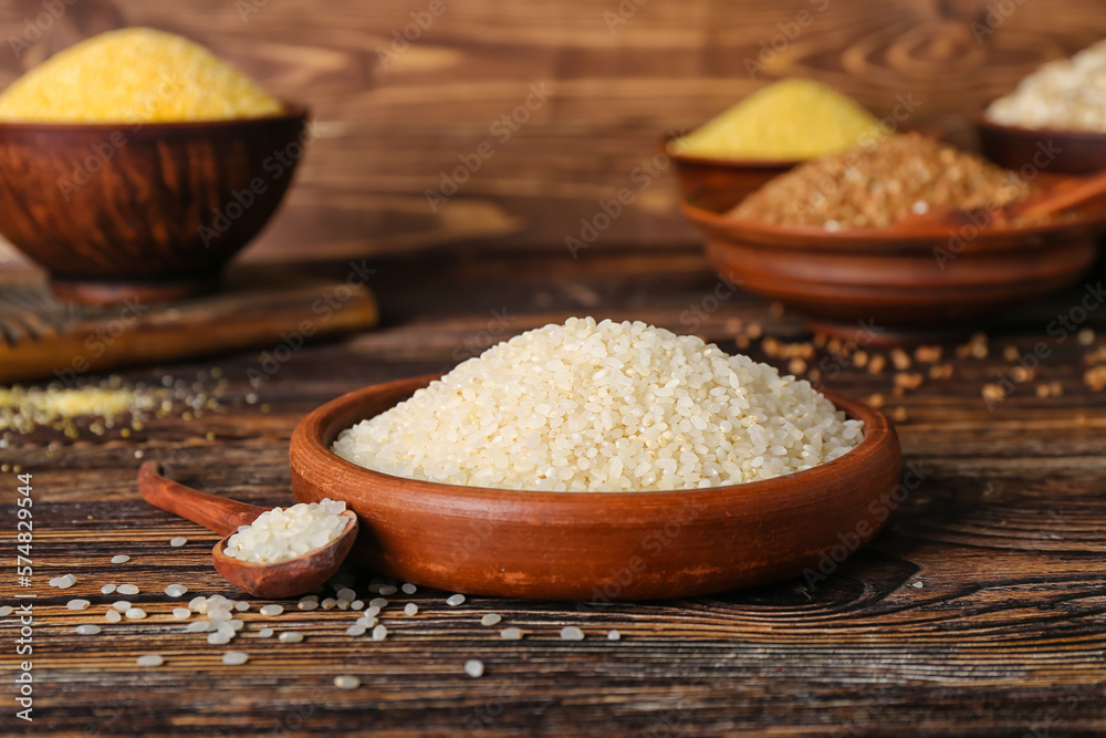 Plate with rice on wooden background