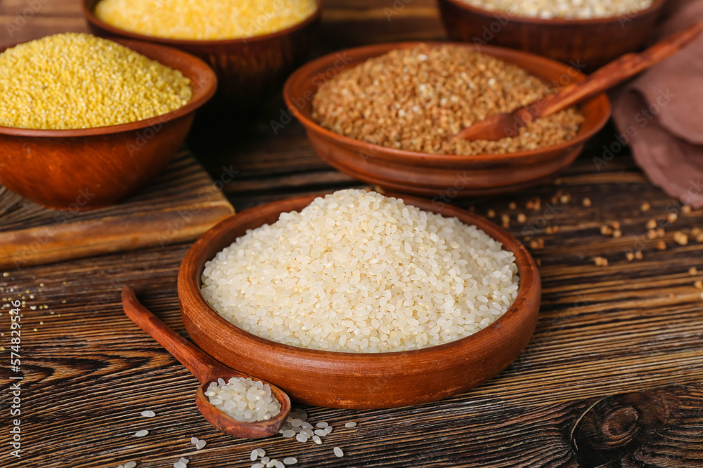 Plate with rice on wooden background